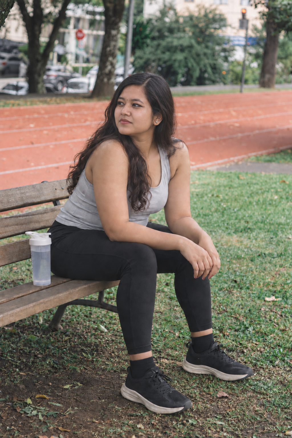 AI-created portrait based on the founder's photographs: an Indian woman with a composed expression looking toward the headline as she rests after a workout